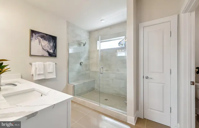 a bathroom with a shower a sink and a mirror