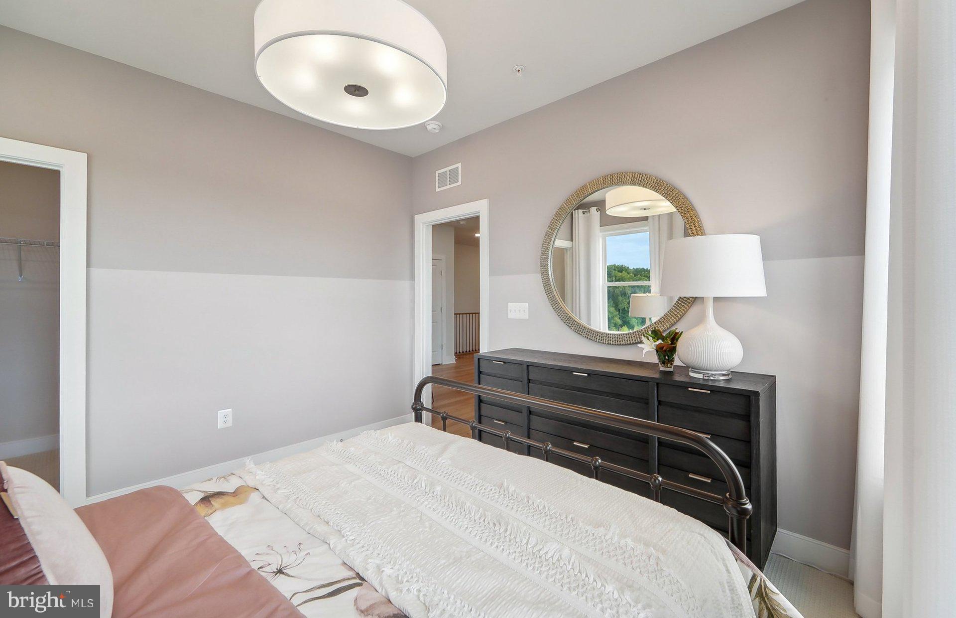 14406 Dowitcher Way Boyds, MD 20841 - Photo 27 of 52 a bedroom with a bed and a mirror