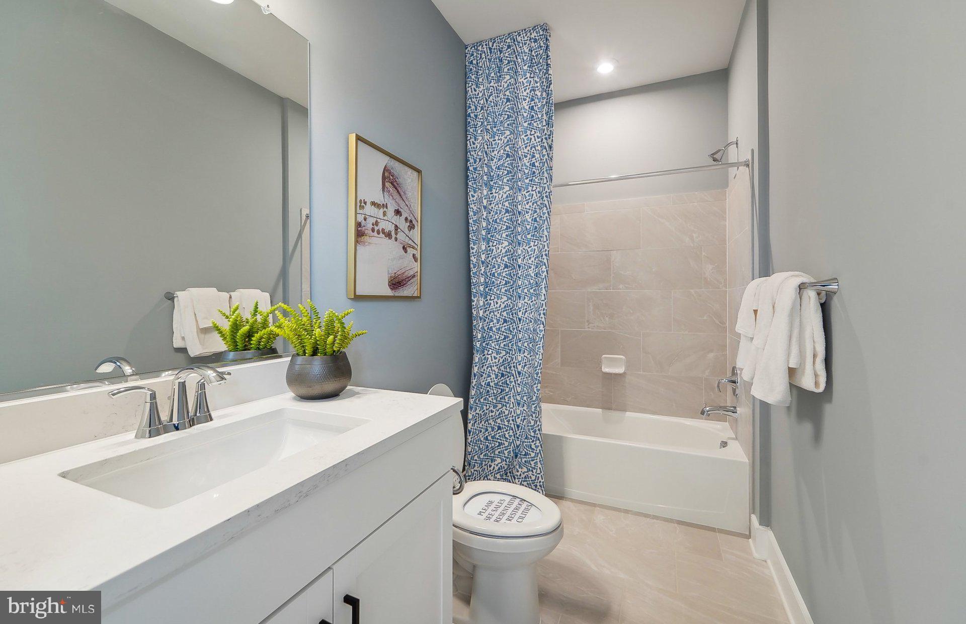 14406 Dowitcher Way Boyds, MD 20841 - Photo 33 of 52 a bathroom with a sink a toilet and shower