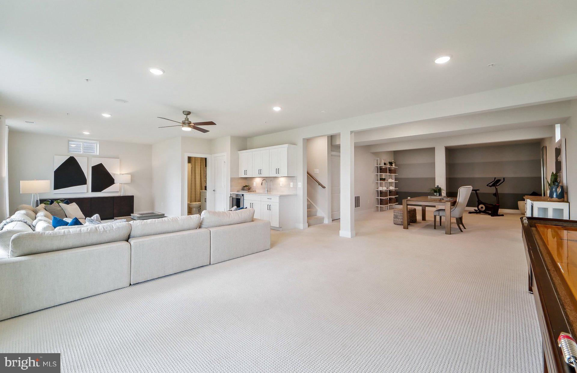 14406 Dowitcher Way Boyds, MD 20841 - Photo 36 of 52 a living room with furniture and a table