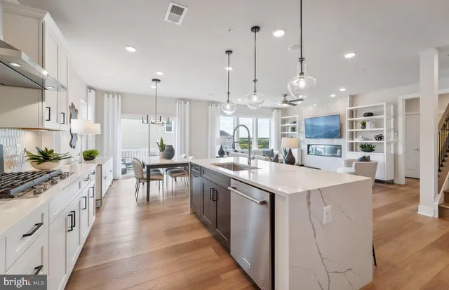 a kitchen with stainless steel appliances kitchen island a large island in the center and cabinets