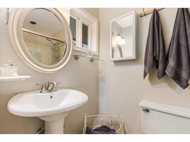 a bathroom with a sink a mirror and a toilet