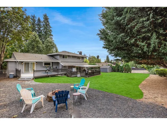 a view of a house with a yard table and chairs