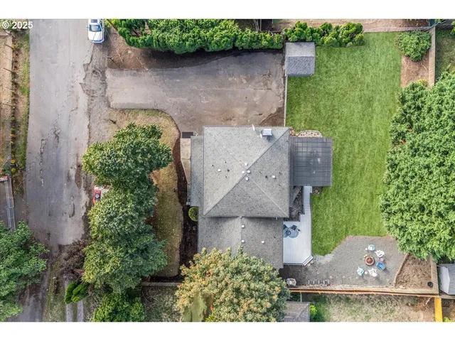 an aerial view of a house with a garden and a yard
