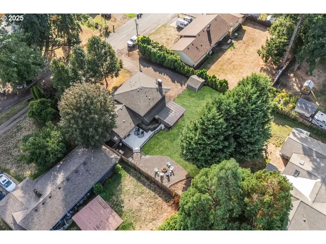 an aerial view of a house with garden space and street view