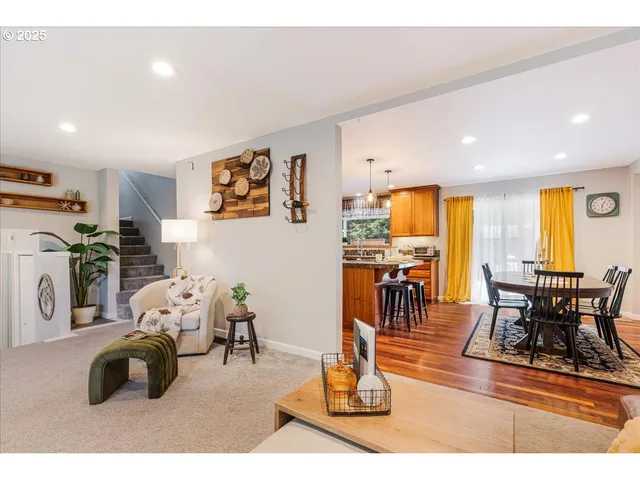 a living room with furniture and kitchen view