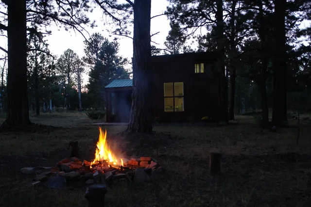 a view of a barn with wooden fence and a bench