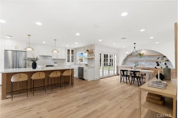 a large kitchen with a table and chairs