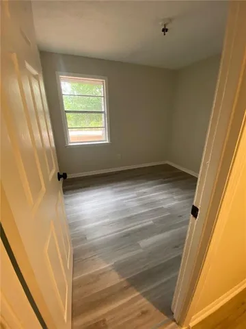 a view of an empty room and wooden floor