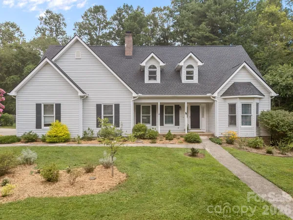a front view of a house with garden and porch