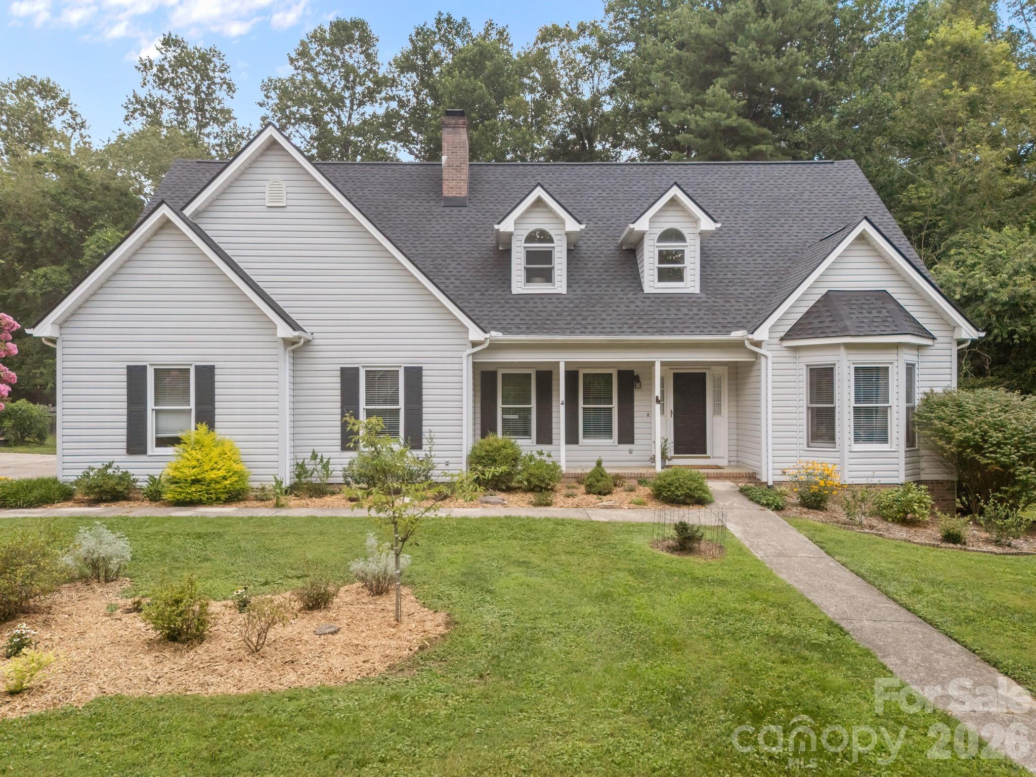 6 Springfield Way Arden, NC 28704 - Photo 1 of 47 a front view of a house with garden and porch