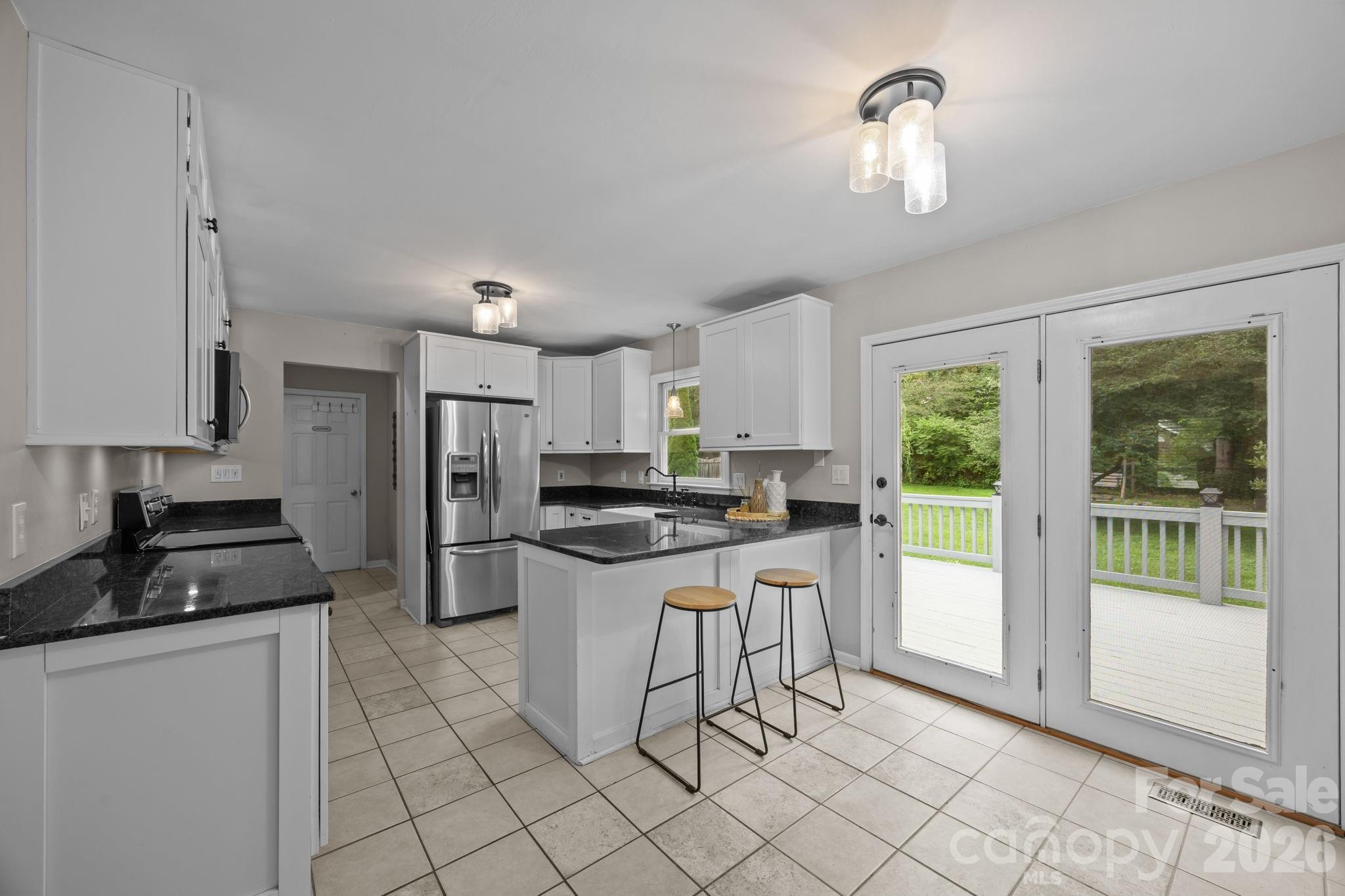 6 Springfield Way Arden, NC 28704 - Photo 14 of 47 a kitchen with a sink a counter top space and stainless steel appliances