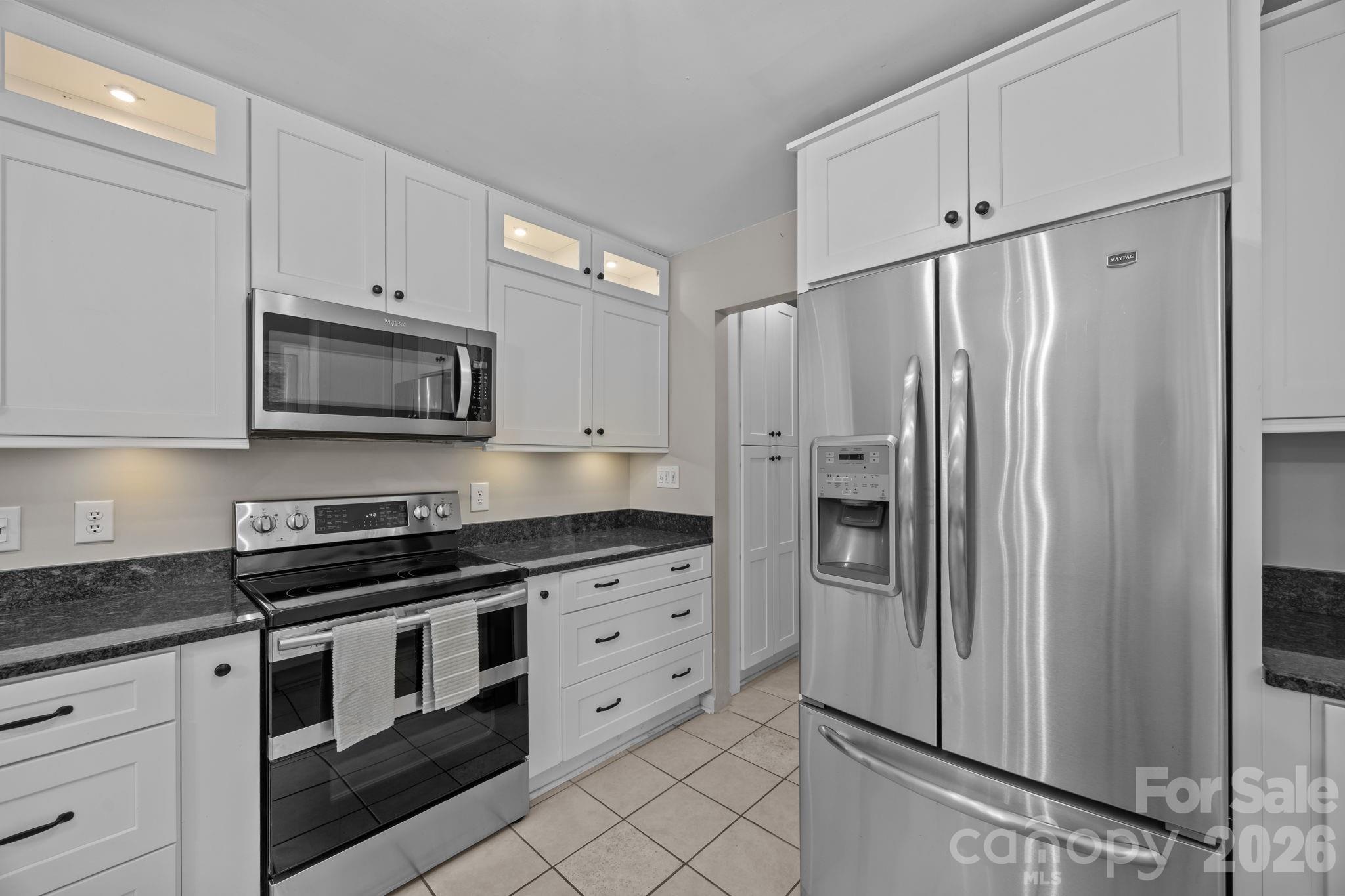 6 Springfield Way Arden, NC 28704 - Photo 17 of 47 a kitchen with stainless steel appliances a refrigerator stove and sink