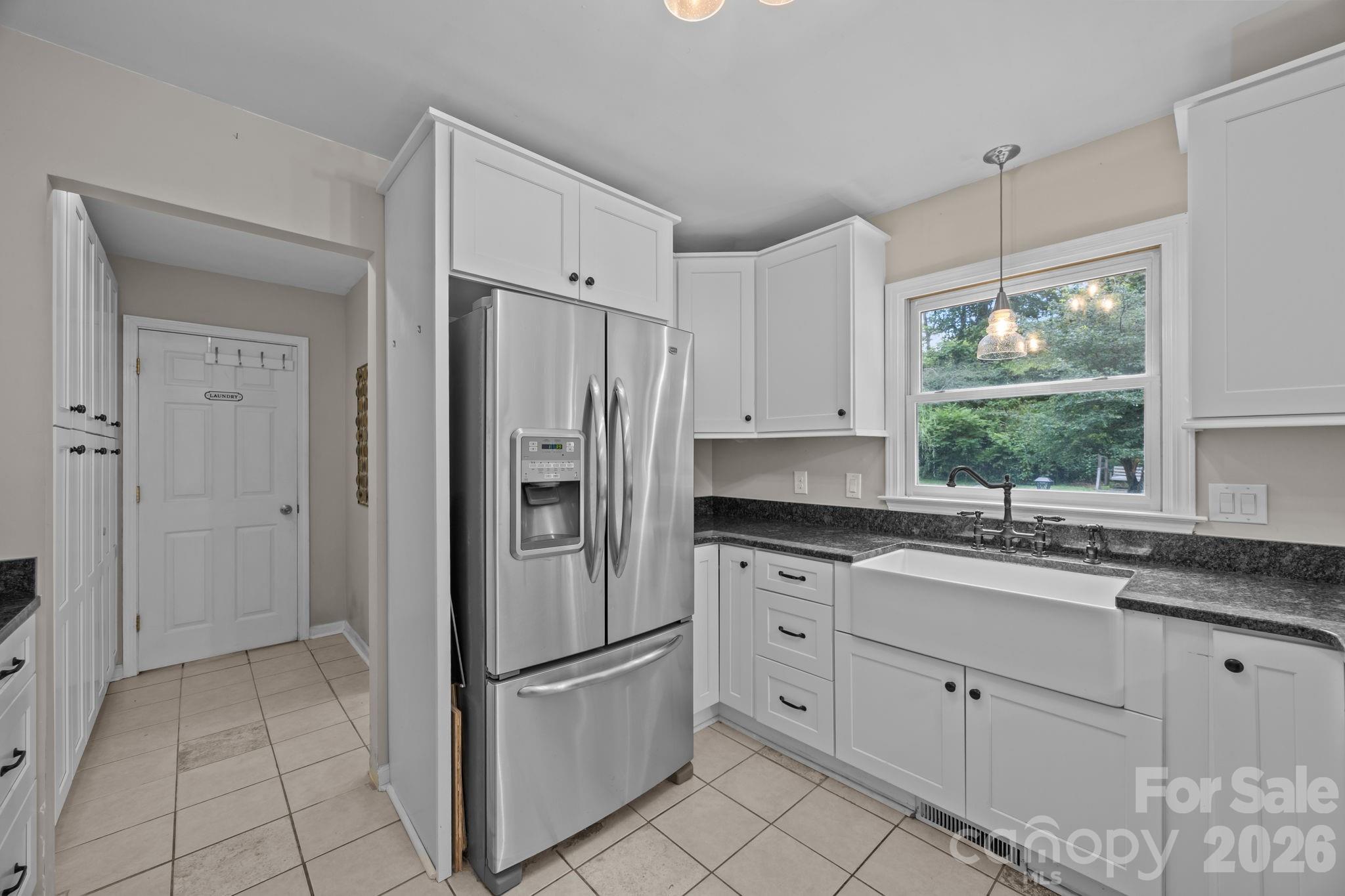 6 Springfield Way Arden, NC 28704 - Photo 19 of 47 a kitchen with white cabinets and window