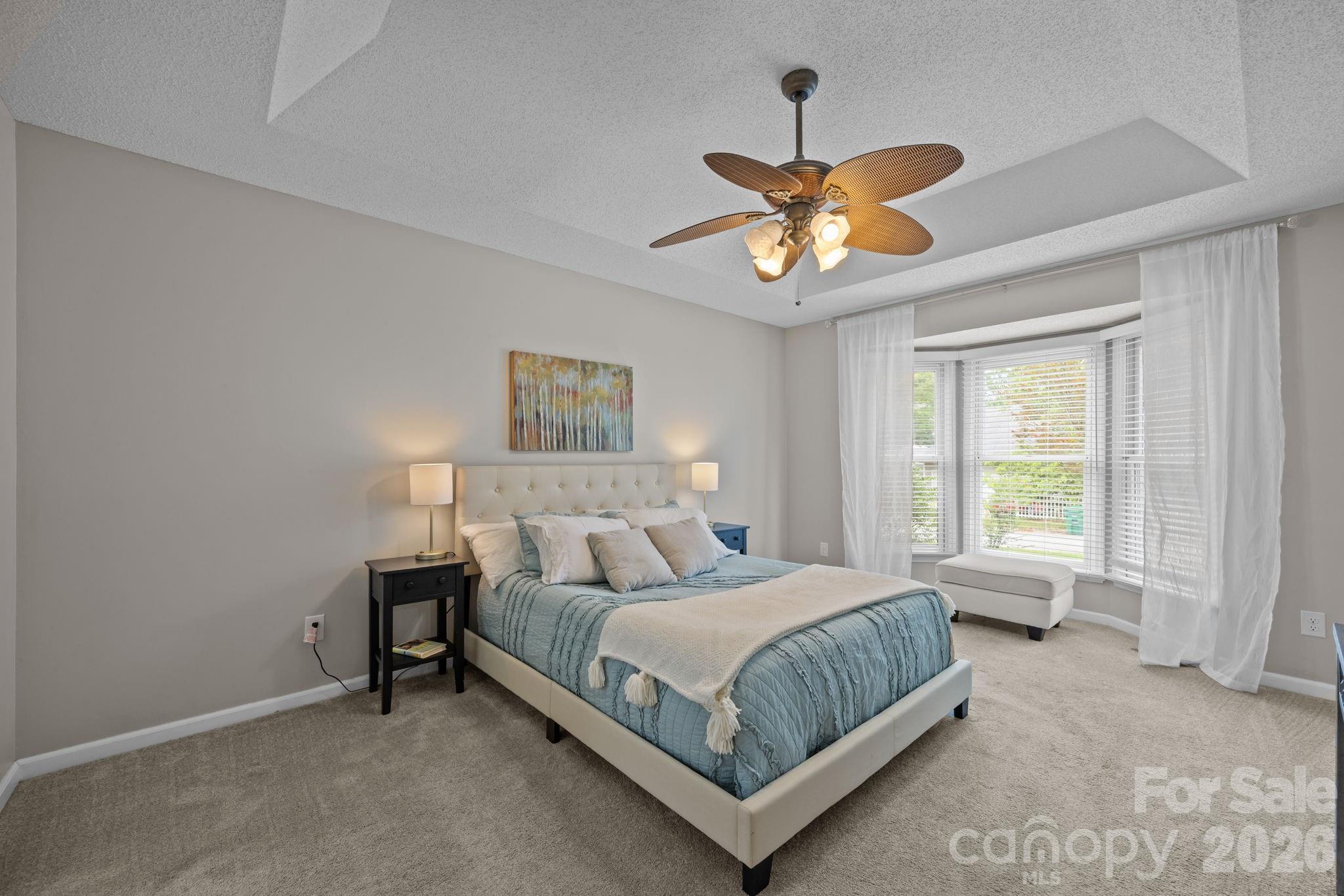 6 Springfield Way Arden, NC 28704 - Photo 21 of 47 a bedroom with a bed and a chandelier