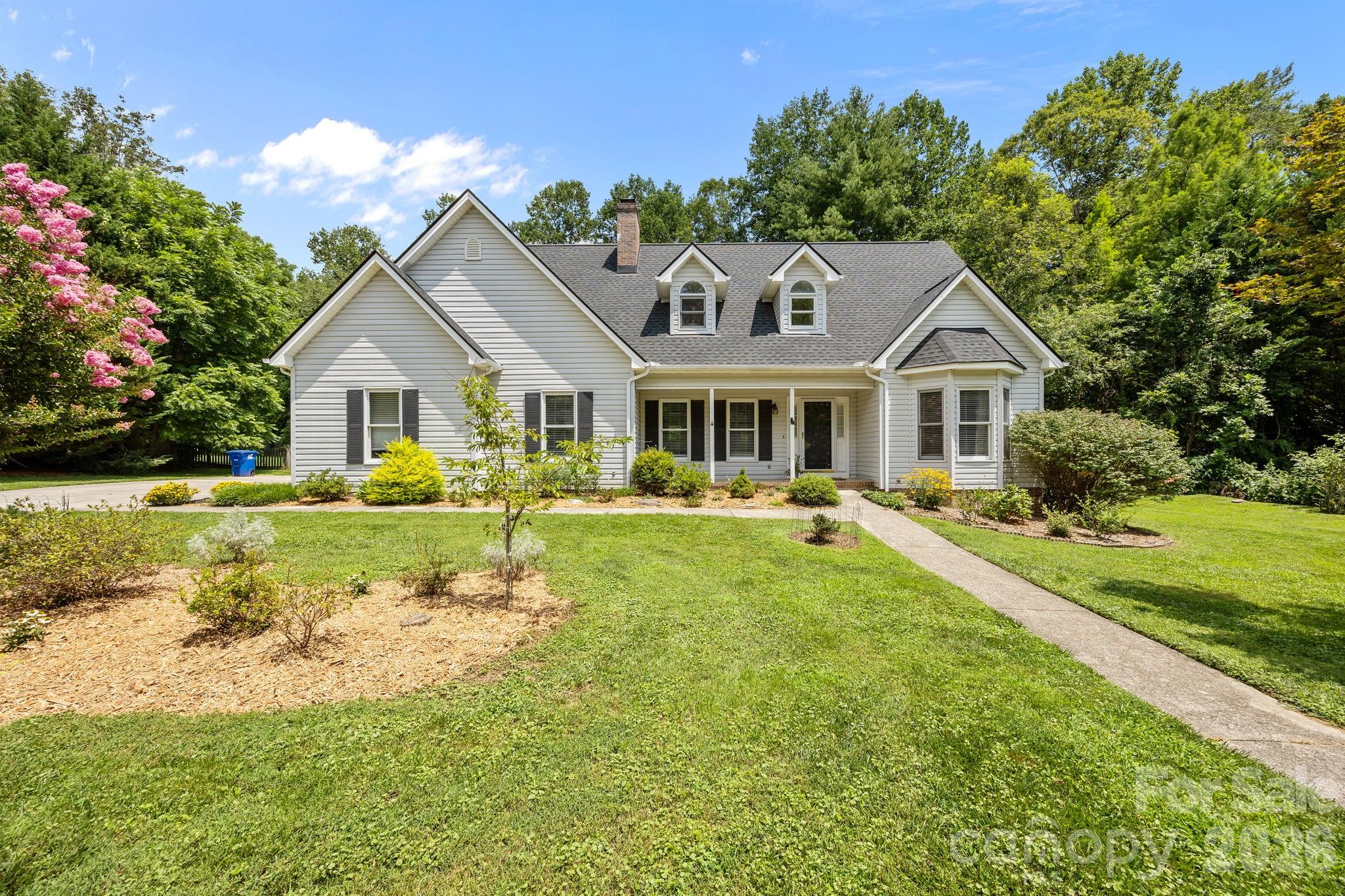 6 Springfield Way Arden, NC 28704 - Photo 44 of 47 a front view of a house with a yard table and chairs