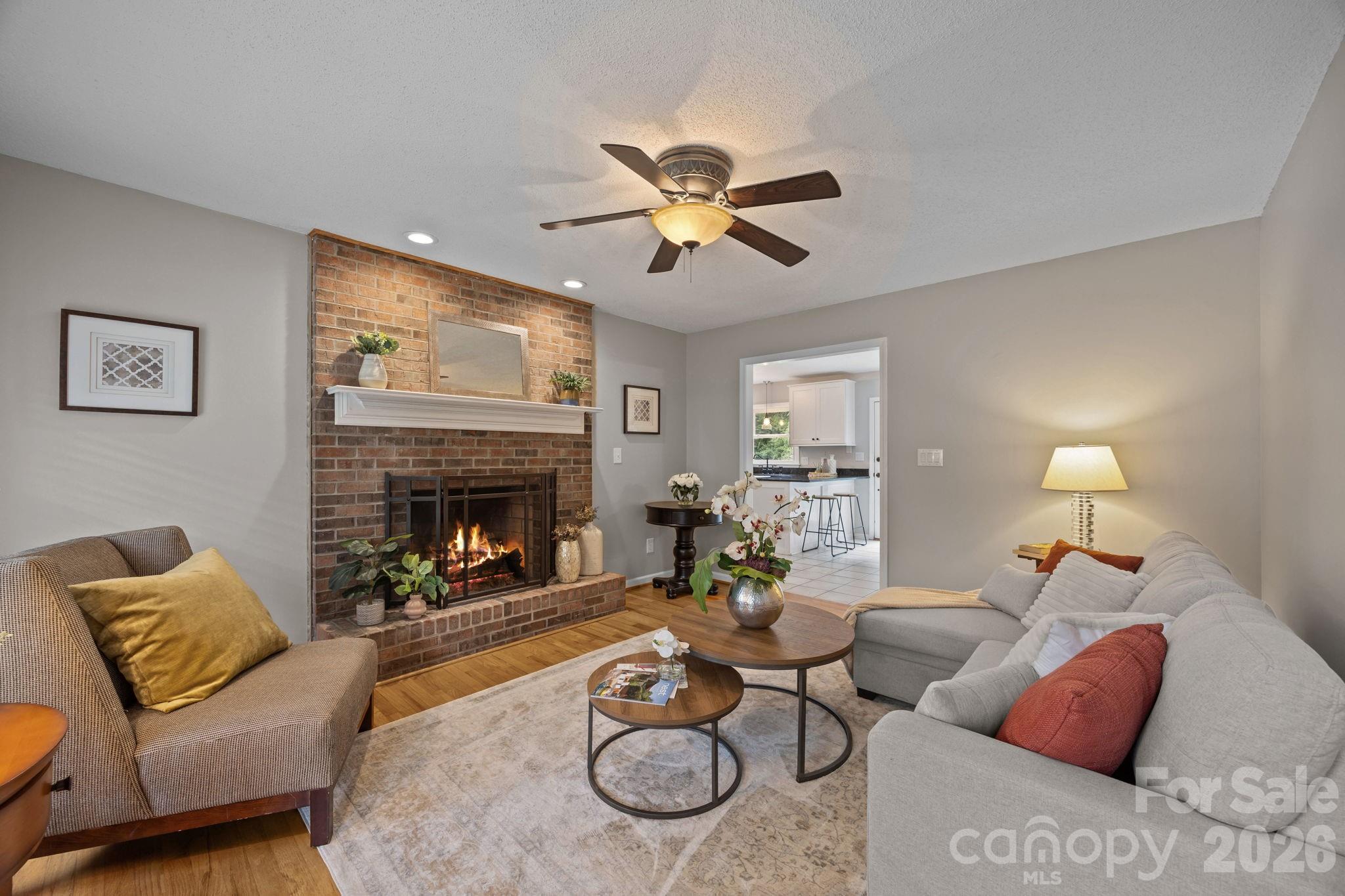 6 Springfield Way Arden, NC 28704 - Photo 5 of 47 a living room with furniture a fireplace and a flat screen tv