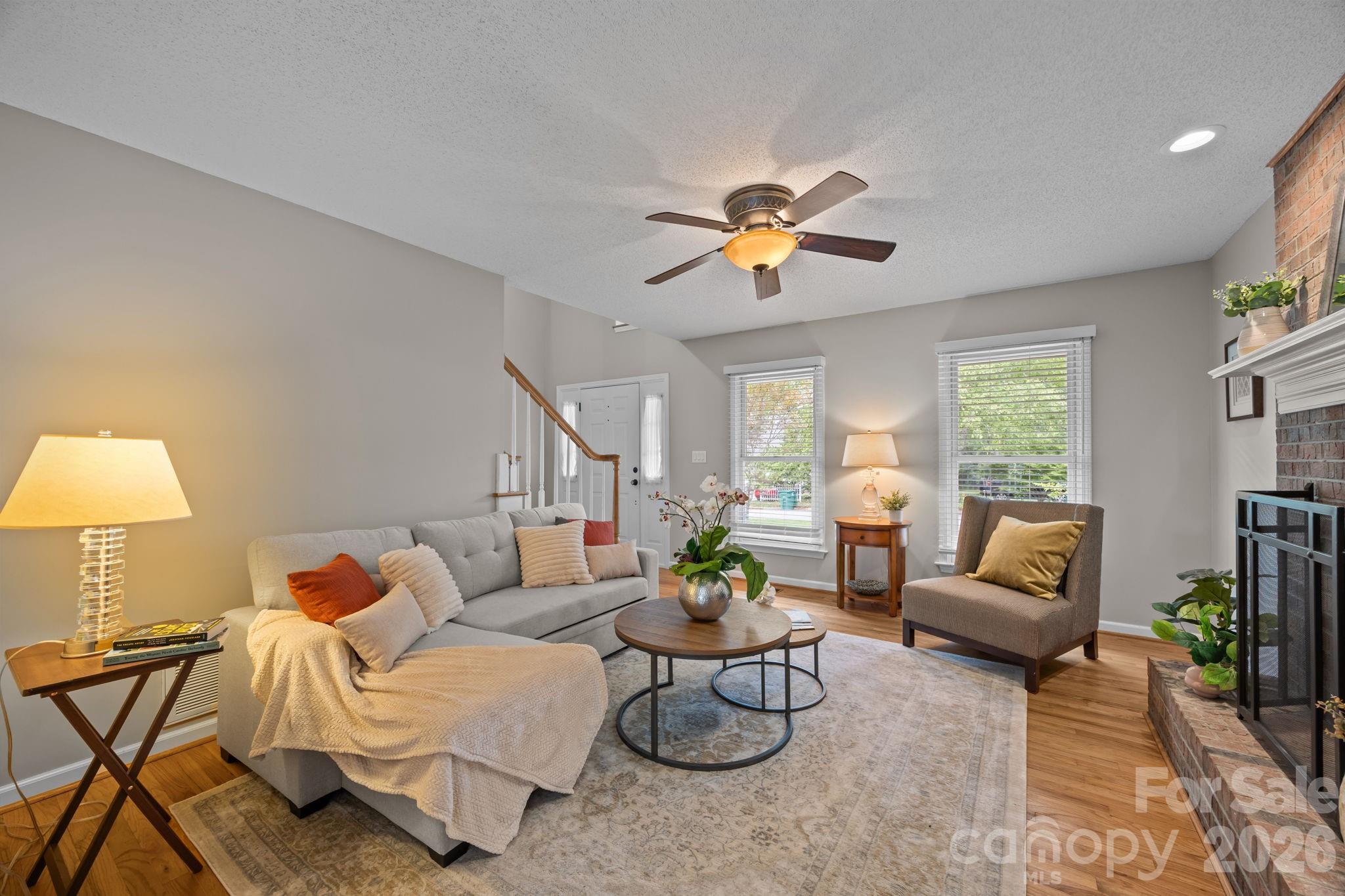 6 Springfield Way Arden, NC 28704 - Photo 6 of 47 a living room with furniture two lamps and a potted plant