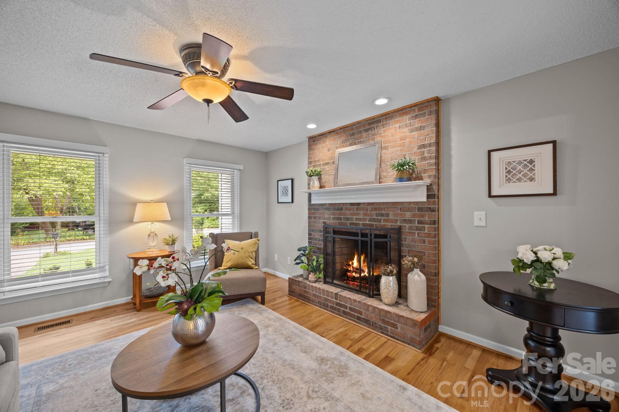 6 Springfield Way Arden, NC 28704 - Photo 7 of 47 a living room with furniture chandelier and a fireplace
