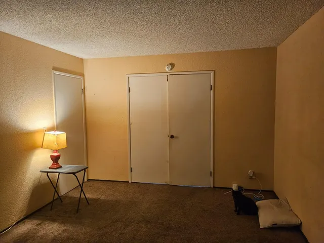 a view of a room with a table and chairs