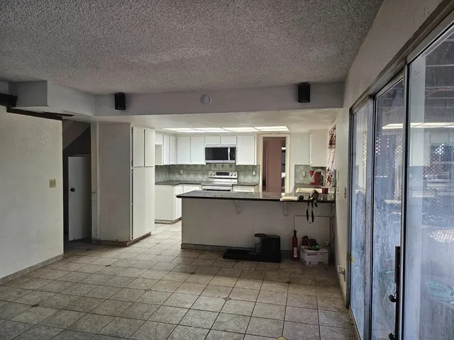 a kitchen with stainless steel appliances a refrigerator and a stove top oven