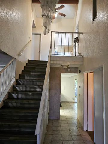 a view of entryway and hall with wooden floor