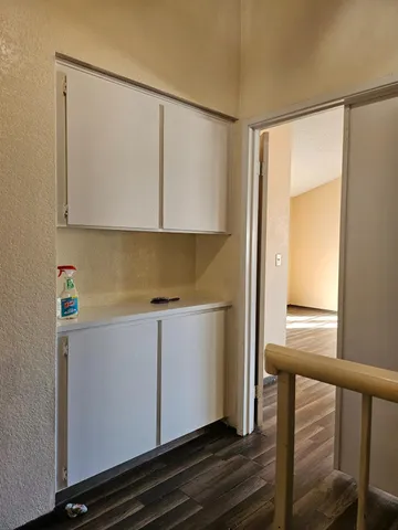a view of cabinets and wooden floor