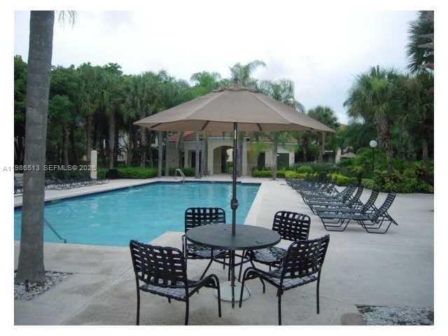 560 South Park Road, Unit 367 Hollywood, FL 33021 - Photo 21 of 28 a view of a patio with table and chairs and potted plants