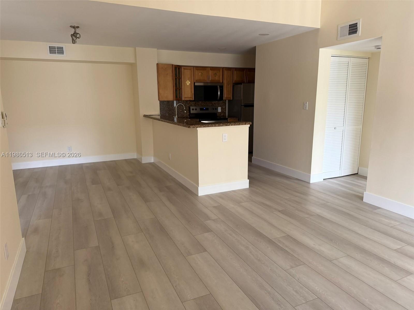 560 South Park Road, Unit 367 Hollywood, FL 33021 - Photo 6 of 28 a view of a kitchen with wooden floor and electronic appliances