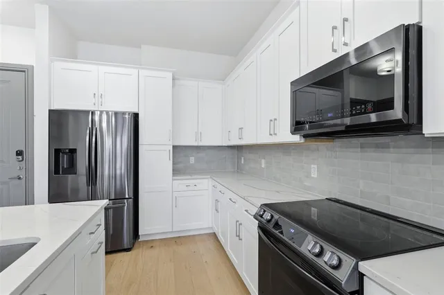 a bathroom with a granite countertop sink toilet and bathtub
