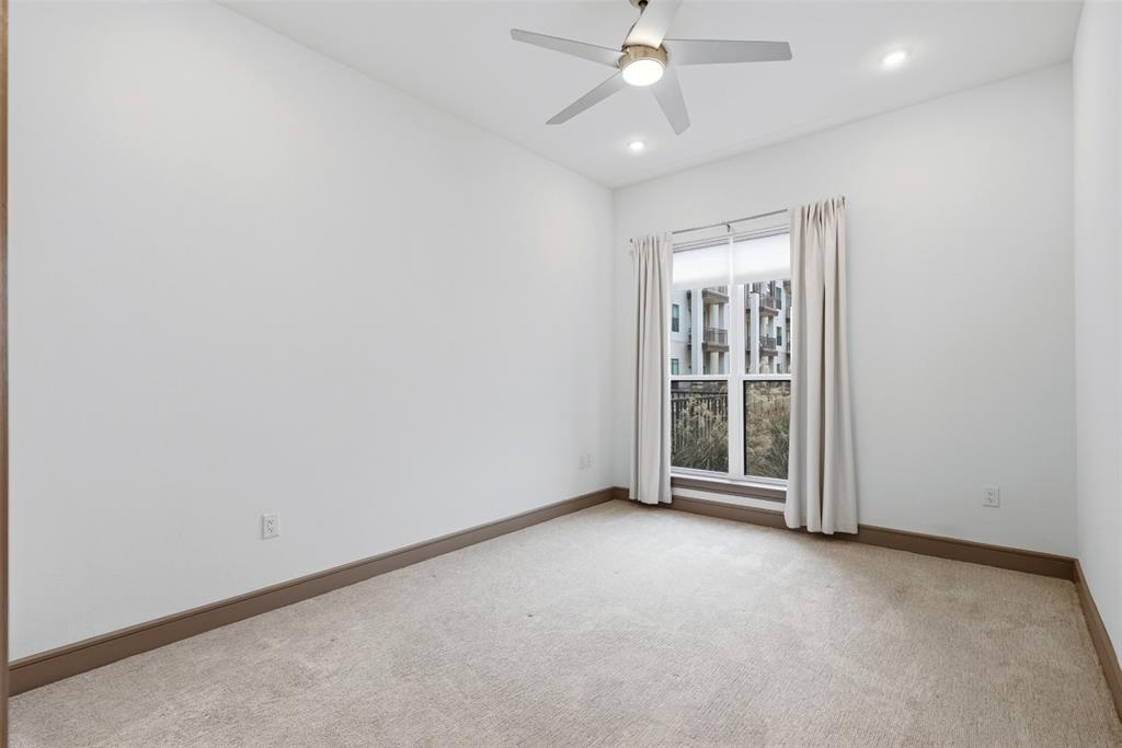 2700 Old Denton Road, Unit 1044 Carrollton, TX 75007 - Photo 16 of 39 an empty room with a ceiling fan and a window