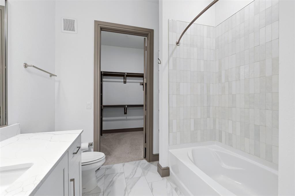 2700 Old Denton Road, Unit 1044 Carrollton, TX 75007 - Photo 17 of 39 a bathroom with a granite countertop sink toilet and bathtub
