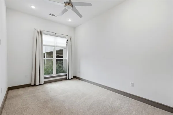 an empty room with windows and entrance