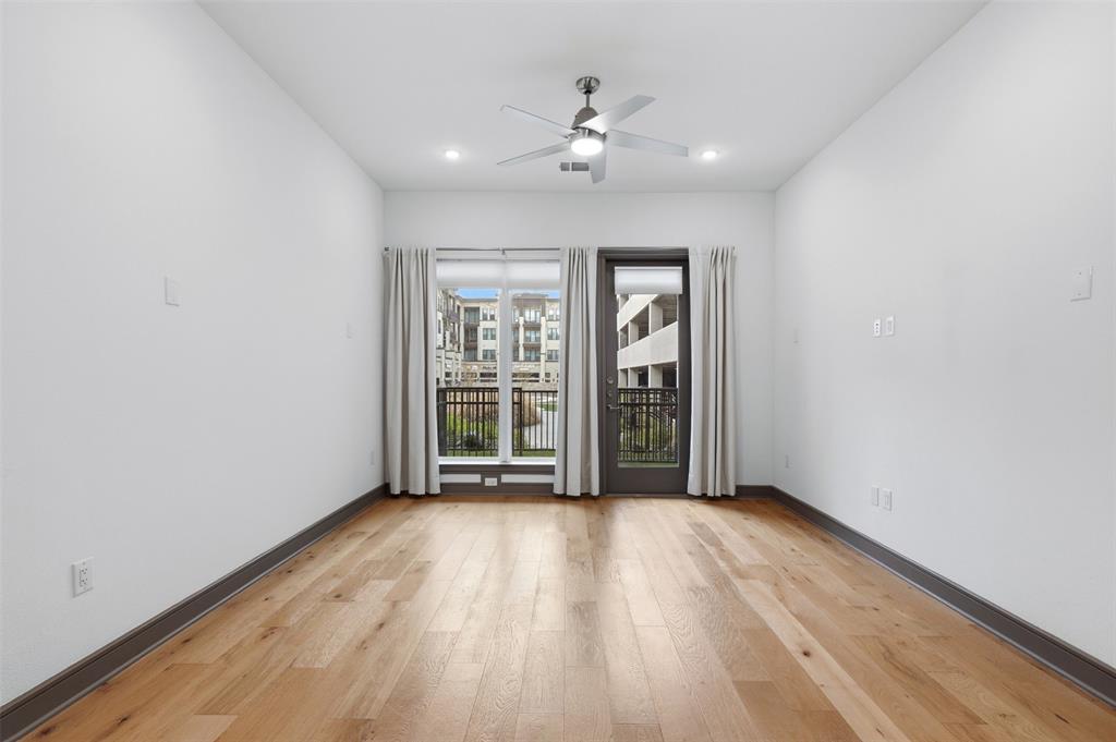 2700 Old Denton Road, Unit 1044 Carrollton, TX 75007 - Photo 20 of 39 an empty room with wooden floor and windows