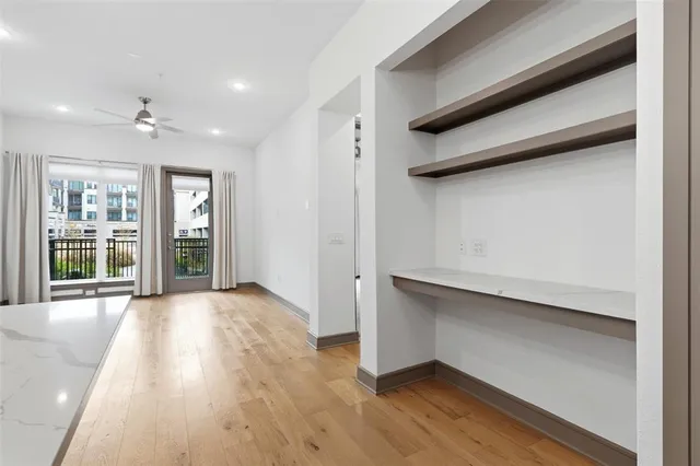 a living room with lots of furniture and a large window