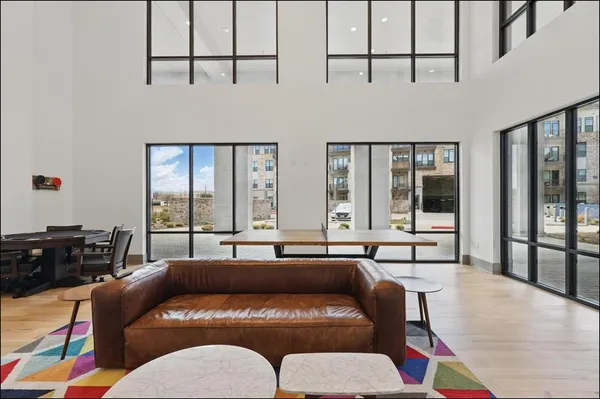 a living room with furniture and large window