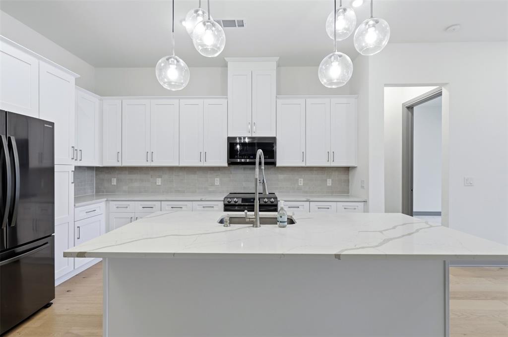 2700 Old Denton Road, Unit 1044 Carrollton, TX 75007 - Photo 6 of 39 a kitchen with a sink a refrigerator and cabinets