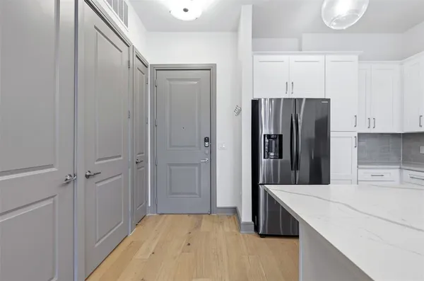 a kitchen with a refrigerator and a sink