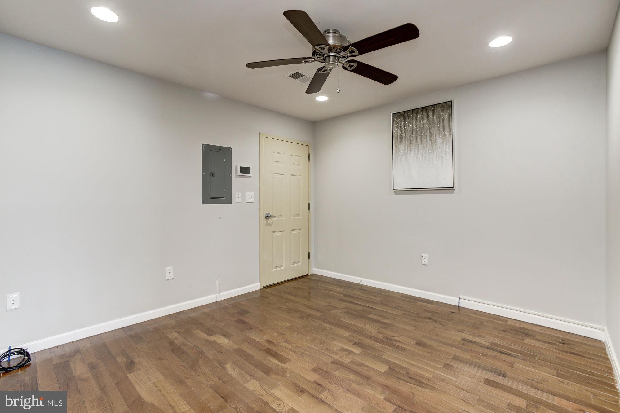 3315 Eastern Avenue, Unit 203 Baltimore, MD 21224 - Photo 2 of 13 an empty room with wooden floor and windows