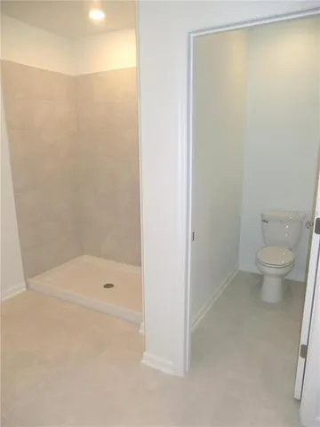 a bathroom with a shower and a toilet