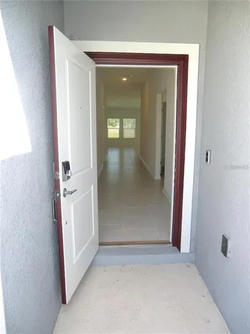 an entryway with wooden floor and a hallway