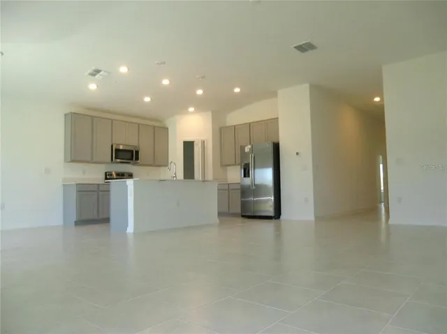 a view of a kitchen with a sink and a refrigerator
