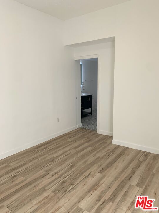 4206 West 29th Street Los Angeles, CA 90016 - Photo 12 of 14 a view of an empty room with wooden floor and a fireplace