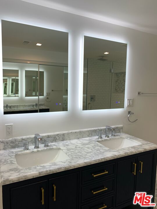 4206 West 29th Street Los Angeles, CA 90016 - Photo 9 of 14 a bathroom with a granite countertop sink two mirror and a