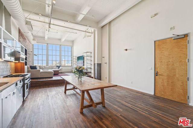 a view of a workspace with furniture and wooden floor