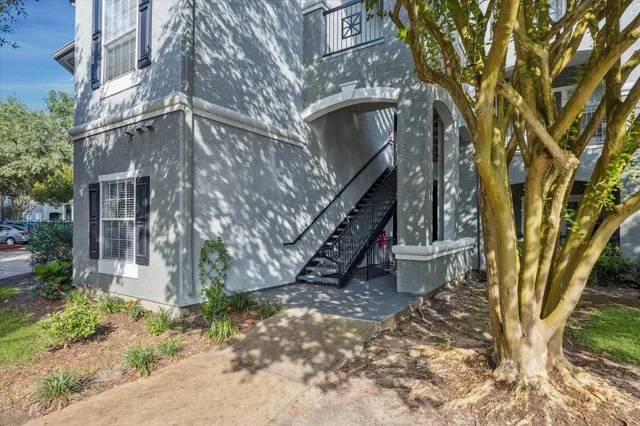a front view of a residential apartment building with a yard