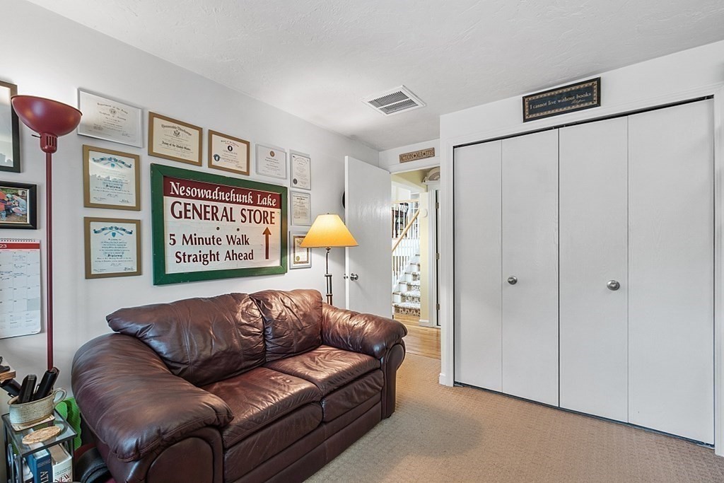 109 C Ridgefield Circle, Unit C Clinton, MA 01510 - Photo 17 of 39 a living room with furniture and a potted plant