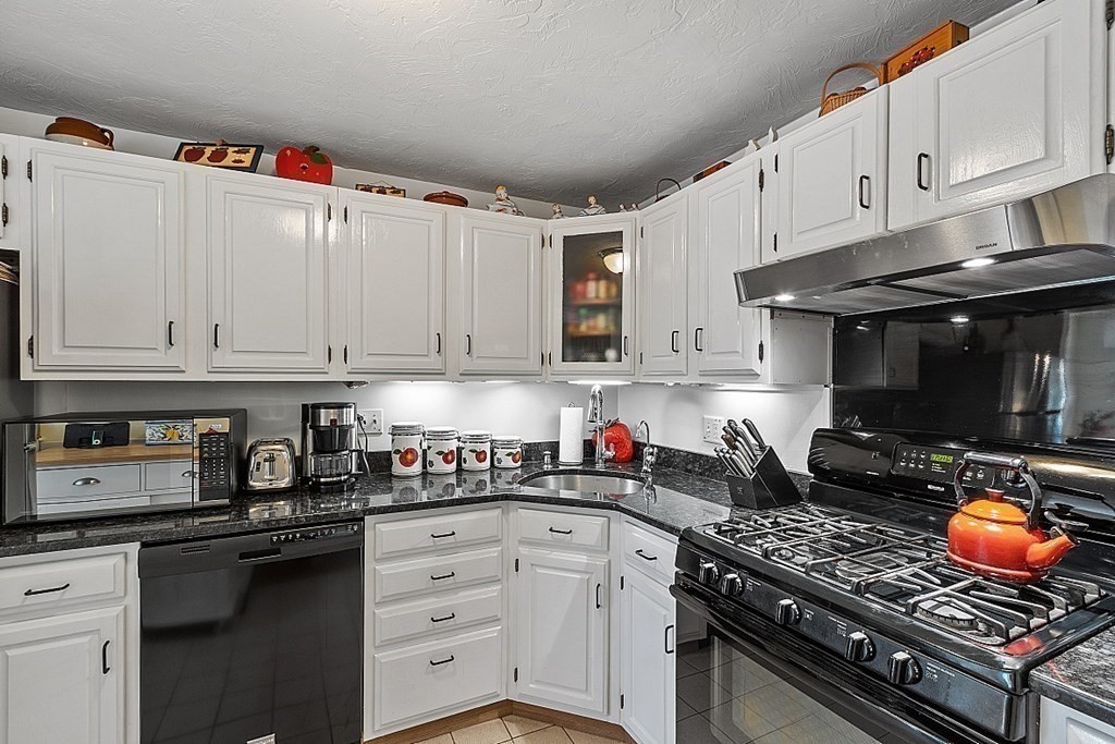 109 C Ridgefield Circle, Unit C Clinton, MA 01510 - Photo 9 of 39 a kitchen with stainless steel appliances granite countertop a stove and a microwave