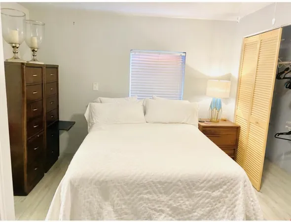 a bathroom with a bathtub and a potted plant