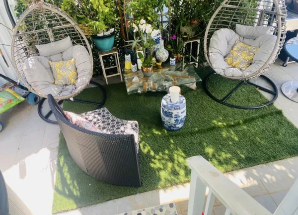 a view of a chair and table in backyard